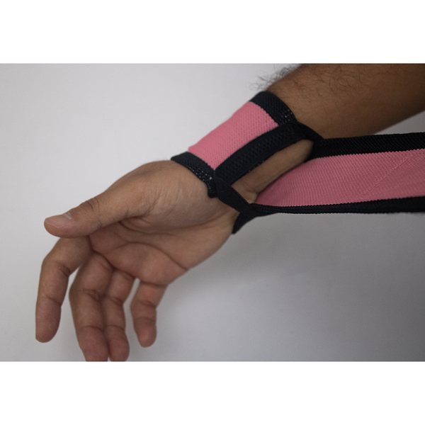 puting on a a pair of Pink wrist wrap 